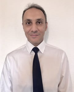 headshot of Dr Kabir against a white wall