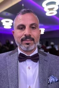 headshot of yousif aawsaj in a grey suit smiling