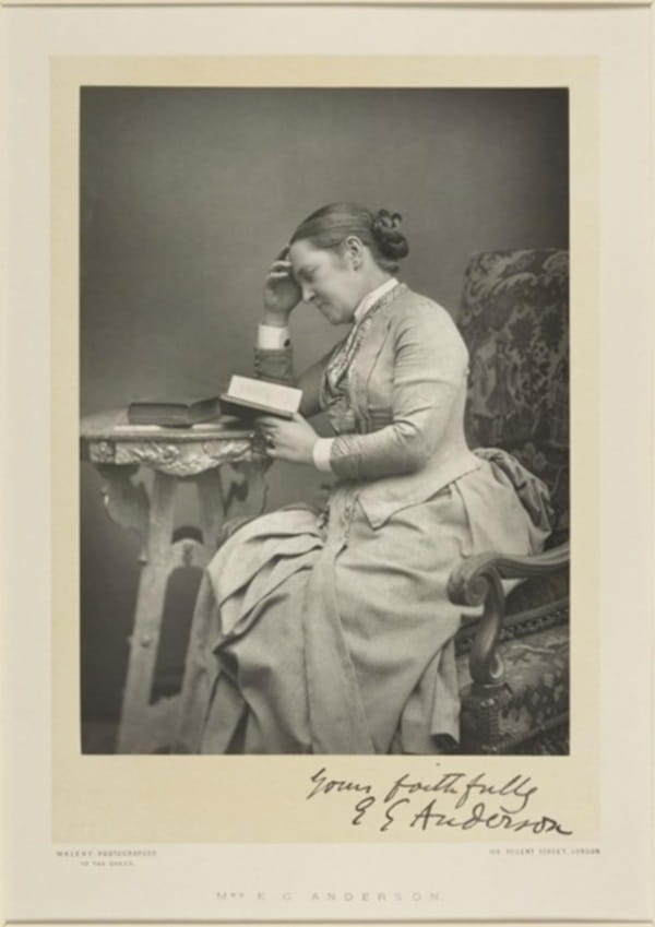 A black and white photograph of a woman reading a book, signed "yours faithfully E G Anderson"