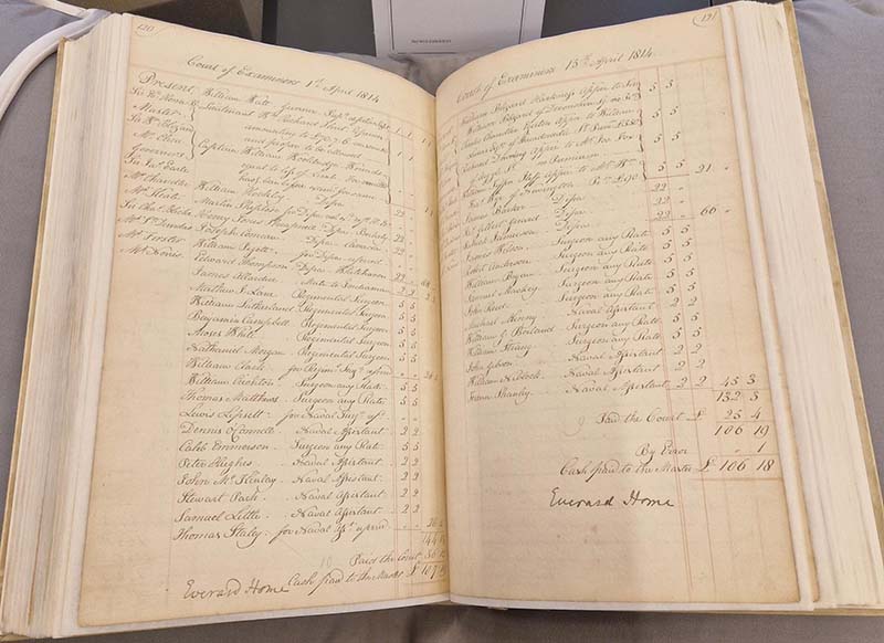 An open registry book with colups of names and numbers