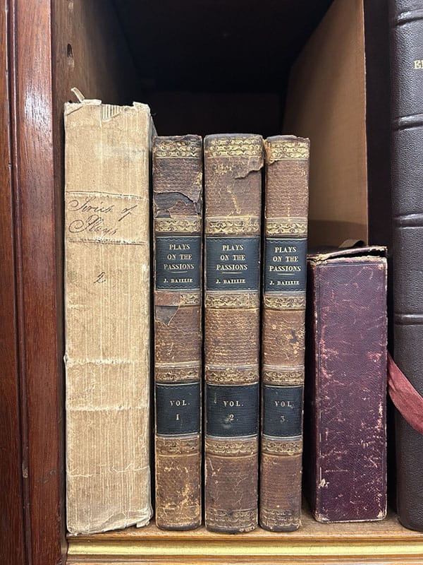 5 bound books and a box on a shelf