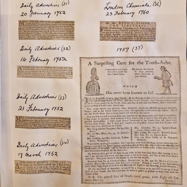 An album page with assorted clippings of advertisements, including a 1757 example entitled 'A Surprising Cure for the Tooth-Ache'.